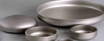 What standards govern the specification of a Buttweld End Cap fitting?